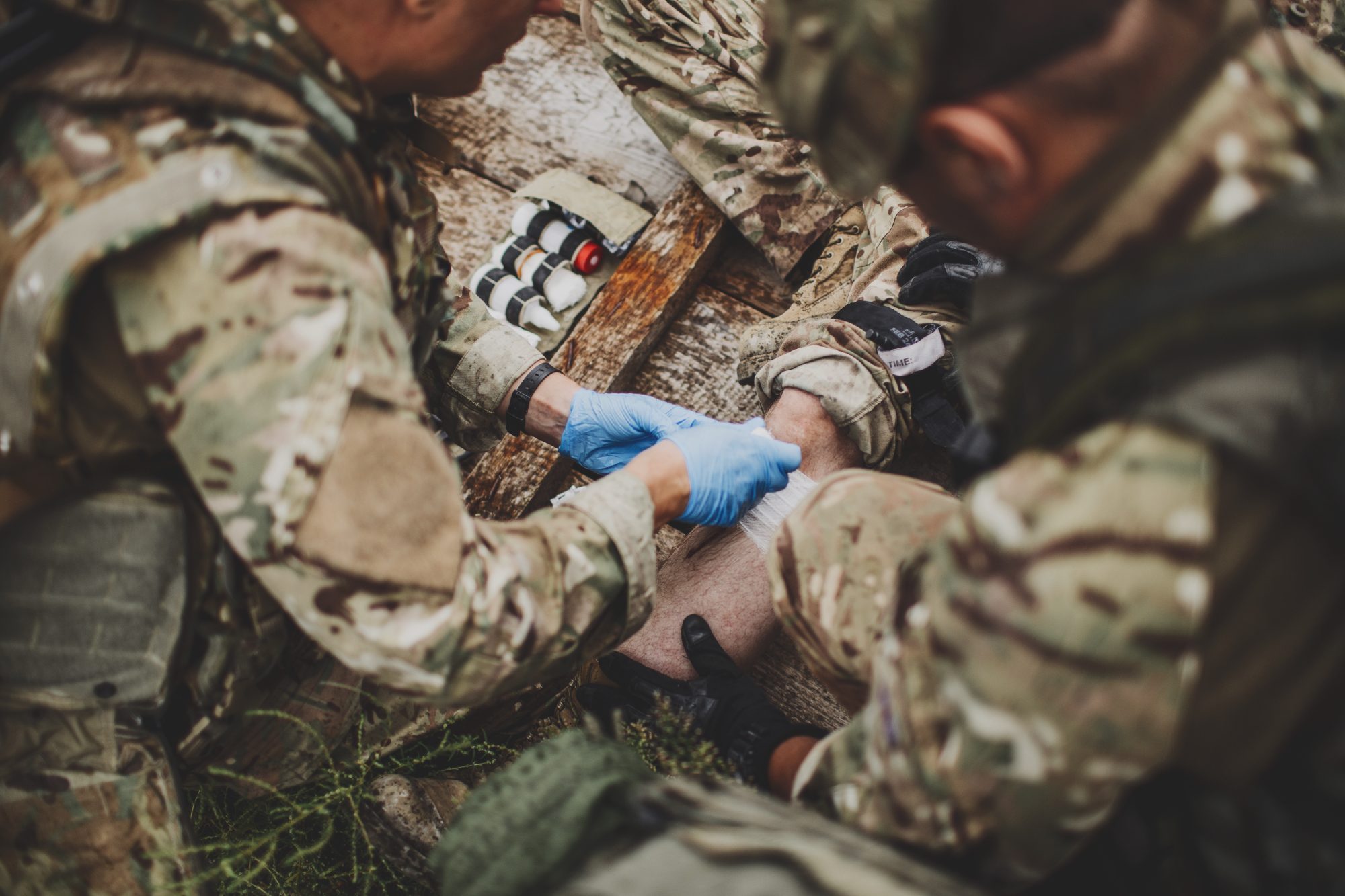 Medics treating a leg wound in the field